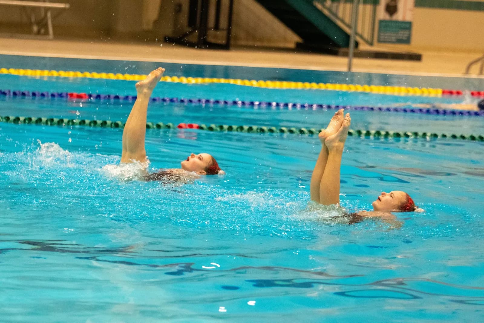 A duet holding vertical leg positions in unison.