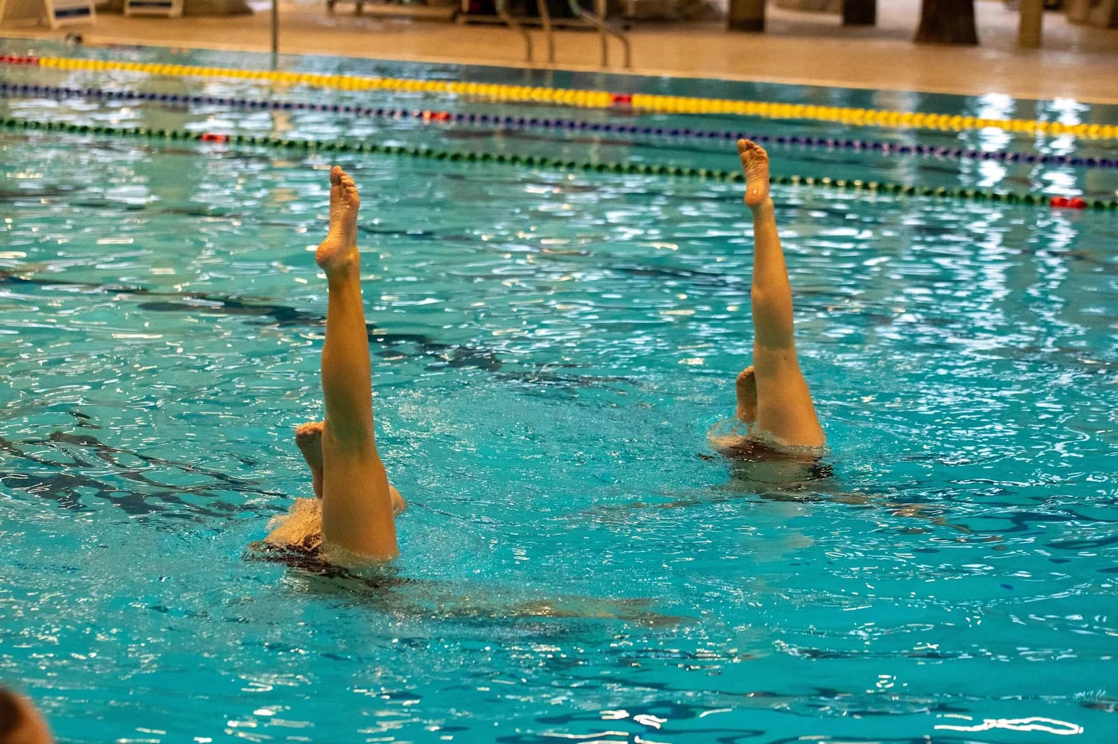 A duet holding matched vertical positions above the surface.