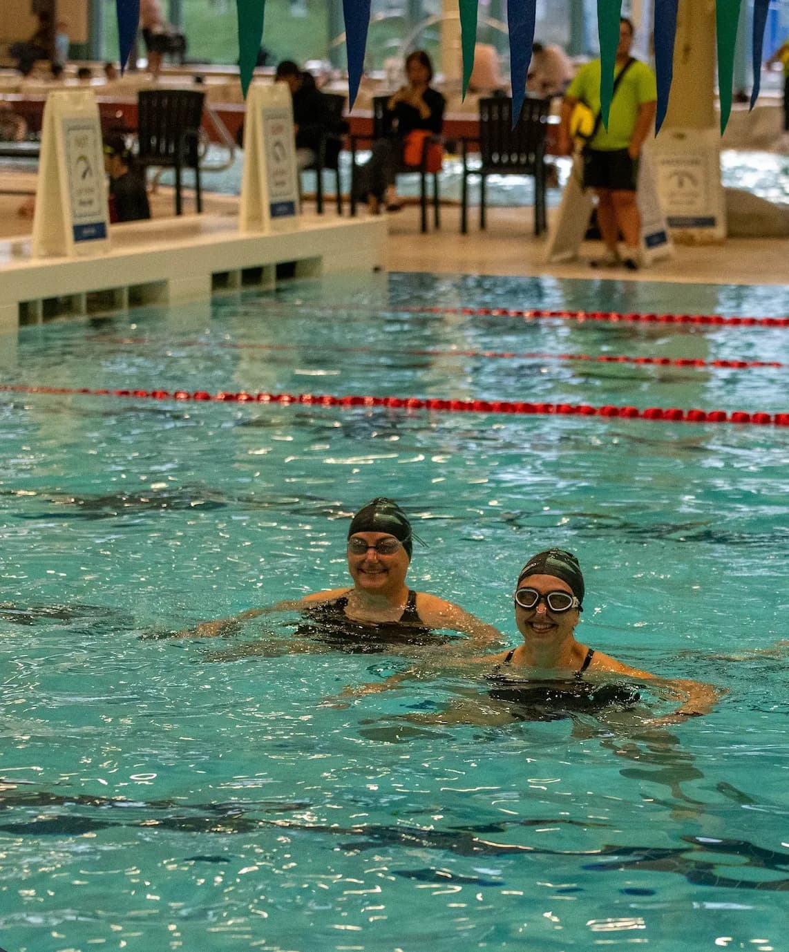Two Masters swimmers treading water together during a session.