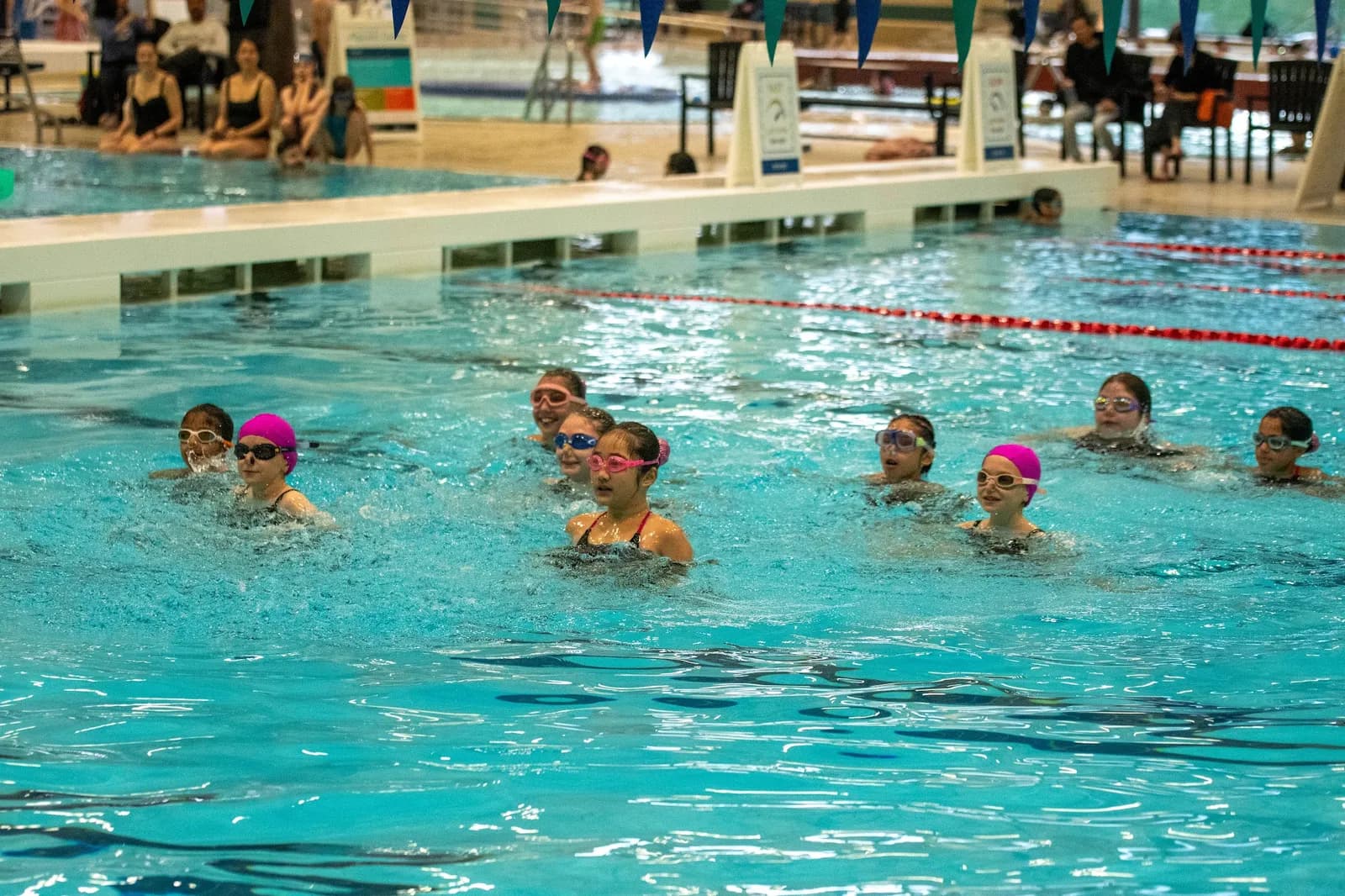 A recreational class treading water together during practice.